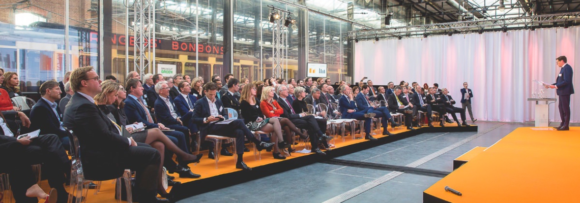 Corporate event photography, conference photography, audience is listening to the speaker on stage, Transformation Forum, Den Haag