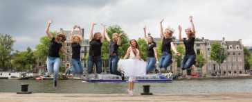 Bachelorette party photoshoot, portrait of a group of friends jumping in the air, celebrating the wife-to-be, Amsterdam