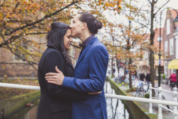 Couple photoshoot, loveshoot, engagement photoshoot, elopement photographer, holiday photographer Amsterdam vacation photographer Amsterdam: man is kissing his girlfriend on her forehead, Delft, The Netherlands