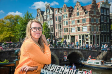 solo portrait, headshot, sunny portrait of a woman posing by Papiermolensluis, near Prinsengracht, Amsterdam