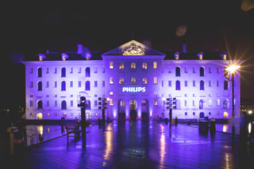 Corporate party photography, corporate event photography, conference photography, photo of the facade of the venue Scheepvaartmuseum, maritime museum, lighted up with the Philips Logo for the gala dinner during ISE Amsterdam