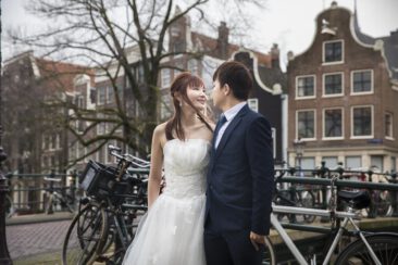 Wedding photography, elopement photographer, engagement and proposal photography, couple photoshoot, an Asian couple, bride and groom, posing near a romantic canal during their elopement, Brouwersgracht, Amsterdam