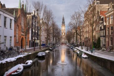 Landscape photography, view of a typical old city center area with a canal in the winter in Amsterdam, for illustration on touristic website, brochure and social media