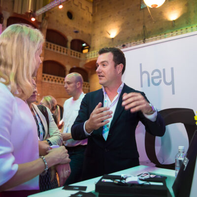 Corporate event photography, conference and trade show, photo of a professional exhibitor explaining his product during CES Unveiled, at Beurs van Berlage, Amsterdam