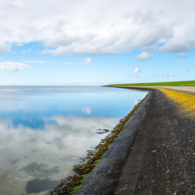 Landscape photography, view of the coastline with a dam on Ameland Wadden island