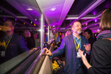 Corporate event photography, party photography, guests enjoying a drink with their colleagues during a corporate gathering on a boat, Amsterdam