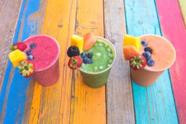 Food and restaurant photography, branding and product photography, photo of colorful vintage wooden table with colorful mouthwatering fruit smoothies, Cup a la Cake, Amsterdam