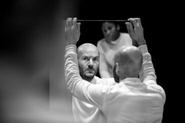 Event photography, festival photography, theatre photography, black and white portrait of a comedian looking at his reflection in a mirror, Answers in Theater de Generator in Leiden