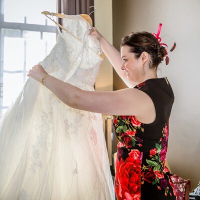 Wedding photography, the bridesmaid is preparing the bridal dress, Amsterdam