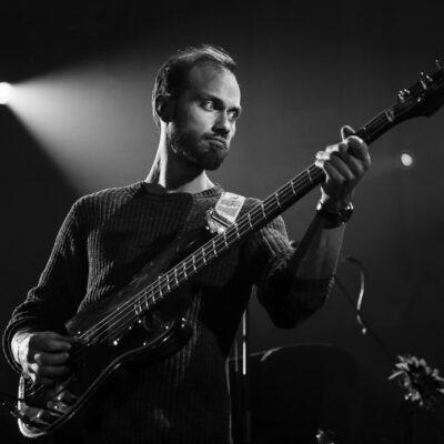 Concert photography, black and white portrait of bass player of Belgian band Delv!s, performing at Paradiso, Amsterdam