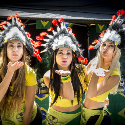 Festival photography, 3 young Brazilian ladies are sending the viewer a kiss at Amsterdam Roots Festival, Oosterpark, Amsterdam