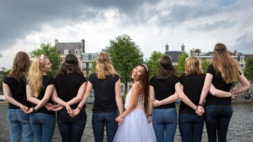 Bachelorette party photography EVJF, a group of ladies friends posing around the bride-to-be, having a good time, laughing, Amstel, Amsterdam