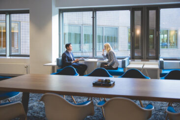 Interior photography, branding photography, corporate lifestyle photography, interior lifestyle photo of two colleagues working together at Randstad main office in Amsterdam