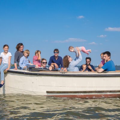 Lifestyle family photography, happy family together on a boat trip on a sunny day, Monnickendam