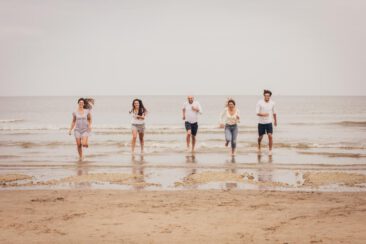 Family photoshoot, sibling sisters and brothers running on the beach in Zandvoort, The Netherlands