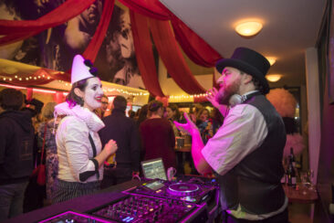 Corporate event photography, corporate party photography, Dj and a guest dressed as a clown during the circus-themed Jubilee party of cinema Rialto, Amsterdam