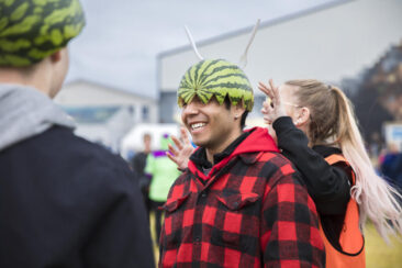 Event photography, festival photography, 2 festival visitors are having fun, wearing watermelon as helmet on their heads, Traena Festival, Norway