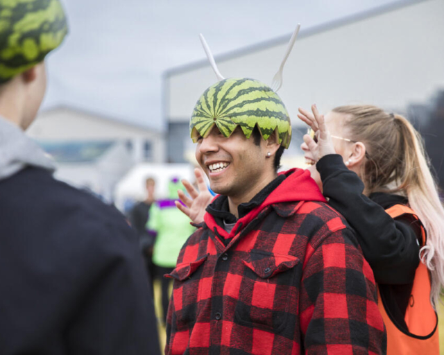 Event photography, festival photography, 2 festival visitors are having fun, wearing watermelon as helmet on their heads, Traena Festival, Norway