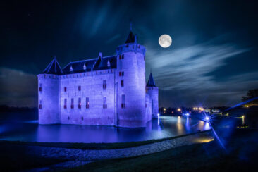 Landscape and nature photography, view of the tourist castle of Muiderslot at night with full moon, photo taken for illustration on website, brochure and social media