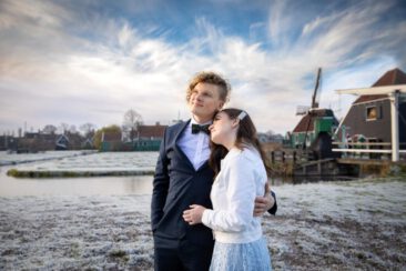 Engagement and proposal photography, couple photoshoot, portrait of a young couple in love with a romantic winter landscape and the windmill of Zaanse Schans, The Netherlands