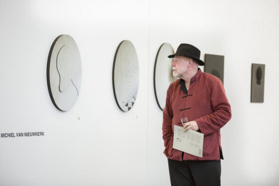 Cultural event photography, a man is looking at an artwork during Kunst Rai exhibition for WOW in Amsterdam