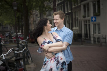 Couple photoshoot, loveshoot, engagement photoshoot, holiday photographer Amsterdam vacation photographer Amsterdam: portrait of a couple posing near the romantic canal Brouwersgracht, looking at each other with love, Amsterdam