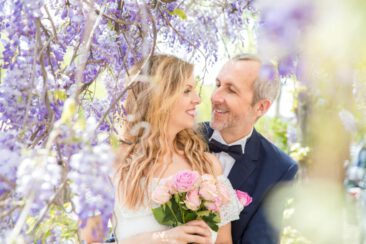 Wedding photography, bride photography, elopement photographer, couple photoshoot, romantic photo of a bride and groom eloping in Amsterdam, posing under a wisteria, Amsterdam