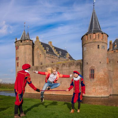 Event photography, photo of a young girl jumping in front of Muiderslot castle during Sinterklaas, Muiderslot, Muiden, The Netherlands