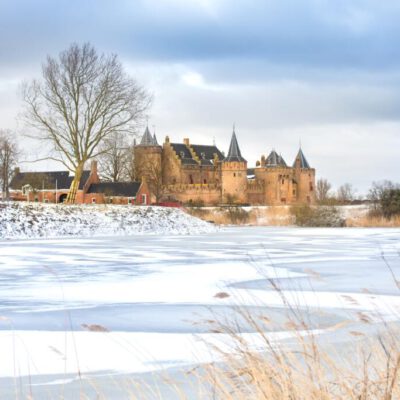 Landscape photography, branding and marketing photography, photo of the Muiderslot Castle and surroundings under the snow in the winter for website and brochure, Muiden, The Netherlands