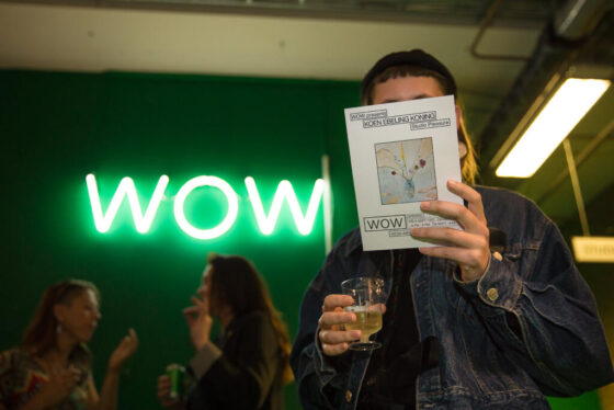 Cultural event photography, a woman is holding the exhibition magazine at opening of exhibition Koen Ebeling Koning, Studio Pleasure at WOW Amsterdam