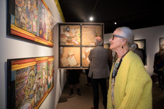 Cultural event photography, a woman is looking at an artwork during opening of exhibition Woest at Outsider Art Museum (Museum van de Geest | Outsider Art in Hermitage Amsterdam