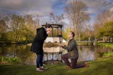 Proposal photography, couple photoshoot, loveshoot, engagement photoshoot: a man is proposing to his girlfriend in front of the kiosk in Vondelpark, Amsterdam
