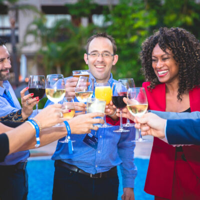 Corporate event photography, corporate party photo of happy colleagues cheering together, Marbella, Spain