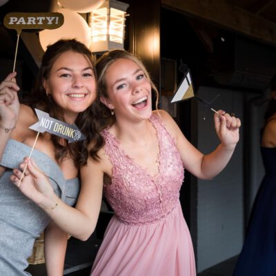 Party photography, birthday photography, young ladies taking a funny pose at a graduation gala party, the Netherlands