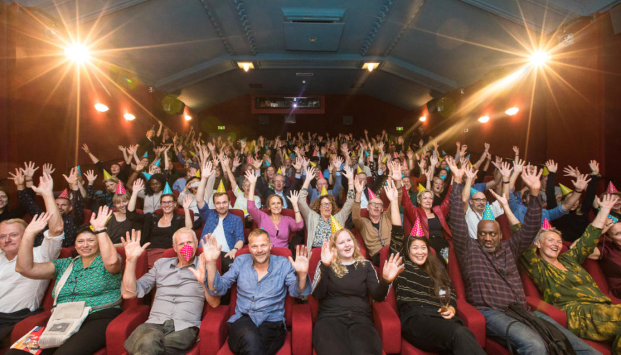 Event photography, festival photography, group picture of people cheering in a cinema during World Cinema Amsterdam festival