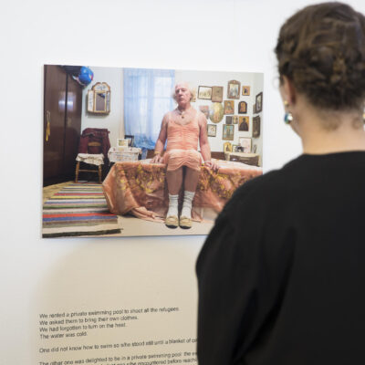 Cultural event photography, a woman is looking at an artwork during Kunst Rai exhibition for WOW in Amsterdam