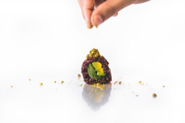 Food and restaurant photography, branding and product photography, shot of a chef sprinkling slivered pistachios on a vegan Maki, Vegan Sushi Bar Amsterdam