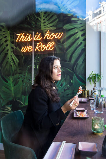 Food and restaurant photography, lifestyle branding and product photography, photo of a client eating her gyozas at trendy Vegan Sushi Bar in Amsterdam