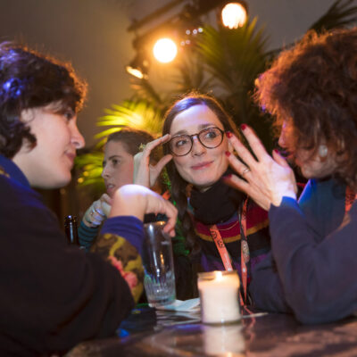Corporate event photography, corporate party photo of colleagues discussing during a party during IFFR Rotterdam, Netherlands