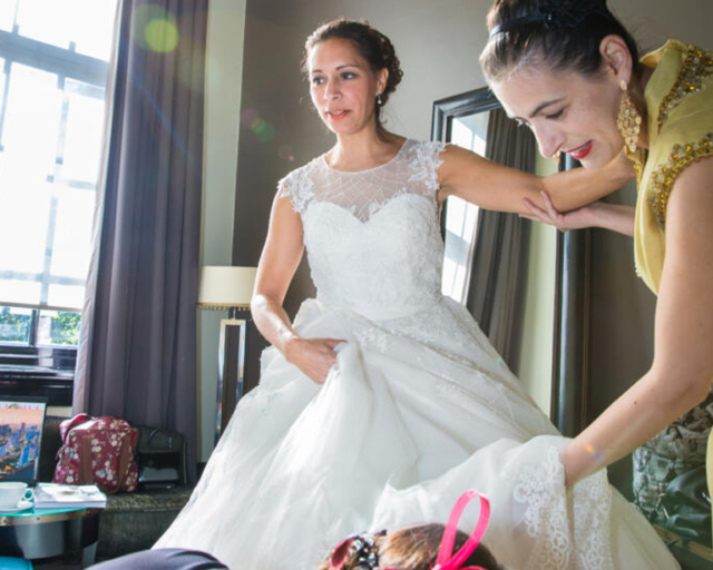 Wedding photography, A bride is getting ready with the help of her bridesmaids in Amsterdam