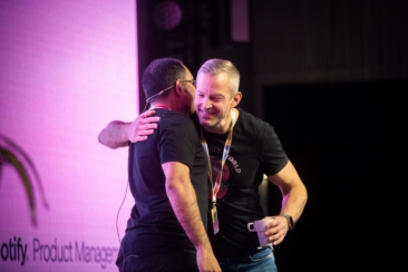 Corporate event photography, conference photography, speakers on stage are hugging each other during a presentation during the Spotify conference in Stockholm, Sweden