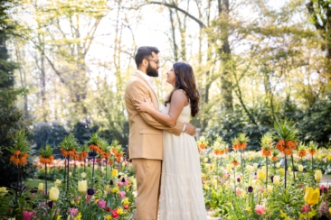 Couple photoshoot, loveshoot, engagement photoshoot: portrait of a couple hugging tenderly in the middle of the flowers Keukenhof Garden, The Netherlands