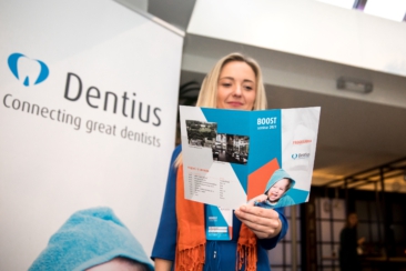 Corporate event photography, conference photography, a participant is reading the conference program booklet the Dentius conference in Amsterdam