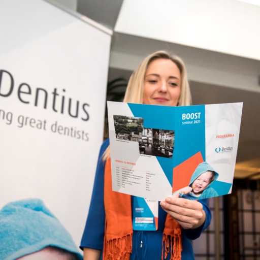 Corporate event photography, conference photography, a participant is reading the conference program booklet the Dentius conference in Amsterdam
