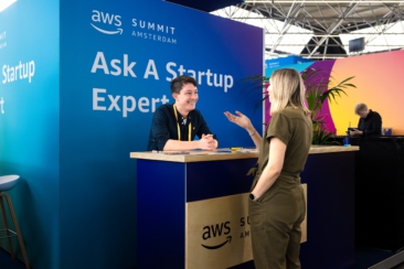 Corporate event photography, conference photography, exhibitor and attendee networking and discussing during AWS Summit in Amsterdam RAI conference centre