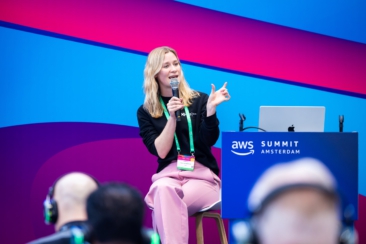 Corporate event photography, conference photography, woman speaking and presenting on stage during AWS Summit in Amsterdam RAI conference centre