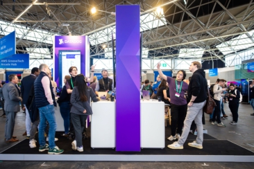 Corporate event photography, conference photography, exhibitors and visitors networking and discussing on booth during AWS Summit in Amsterdam RAI conference centre