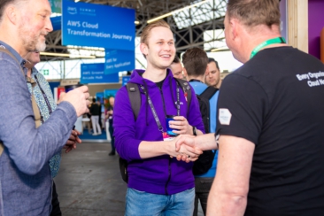 Corporate event photography, conference photography, participants networking and shaking hands during AWS Summit in Amsterdam RAI conference centre
